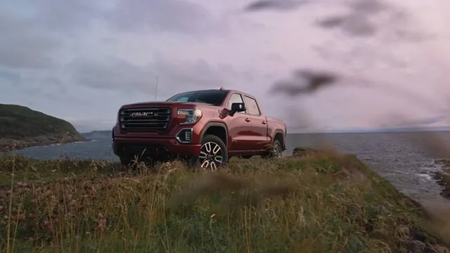 Red GMC Sierra on a cliffside at dusk — 2026 Automotive Reel thumbnail