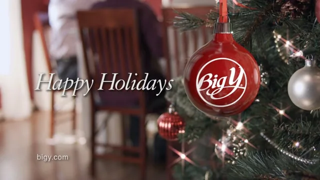 Big Y holiday commercial frame with a red ornament and the words Happy Holidays